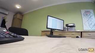 The woman is trying to get a loan from the businessman in the office for business