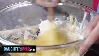 Two stepdaughters bake a pie while playing with each other