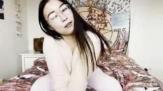 A pretty Chinese babe playing with her pussy on camera
