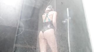 A woman with a wet pussy squirts in the shower