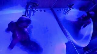 A blonde woman has fun with a large sex toy in the bathroom