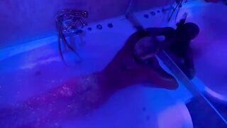 A blonde woman has fun with a large sex toy in the bathroom