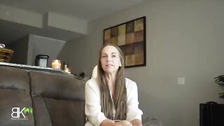 The stepmom is sharing a couch with her stepson in a taboo scene