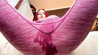 The cute girl is playing with her wet yoga pants