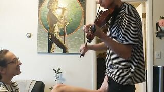 A couple has passionate sex while the girl practices her violin, showcasing real intimacy