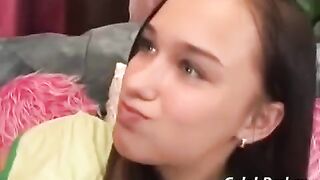 A cute girl has sex with an adult man on the couch in a passionate scene