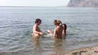 Three sexy girls with puffy nipples playing on the naked beach