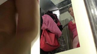 A peeping tom secretly films a girl in the locker room of the store