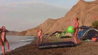 A hot naked game of badminton on the beach