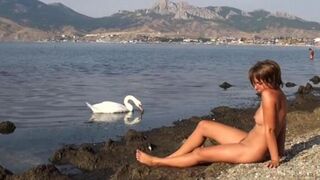 Nude beauty has sex on the riverbank and masturbates