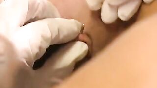 A nice woman plays with her new clit piercing