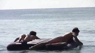 A naked girl is having fun on the beach, showcasing her body