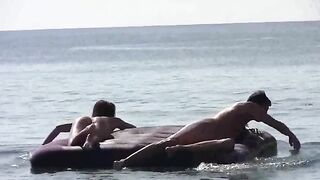 A naked girl is having fun on the beach, showcasing her body