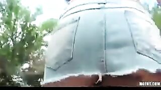 A hot brunette girl plays with her pussy on the city streets