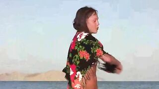 The member shows the girl without clothes on the beach, showcasing nudist vibes