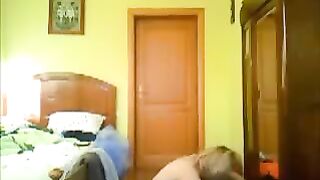 A couple has sex at home, unaware of a peeping camera