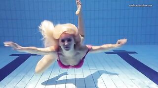 A beauty swims naked in the pool, creating a captivating scene