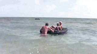 A naked girl is having fun on the beach mattress