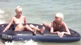 A naked girl is having fun on the beach mattress