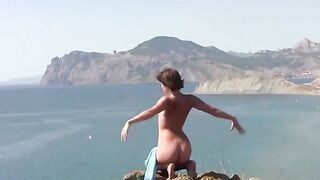 A girl is sunbathing naked on the beach with a great body