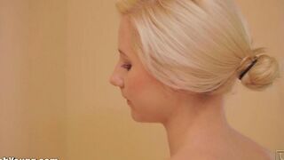Girl caresses herself with a brush in her hands in the bathroom