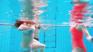 Nude beauties playing in the pool without any clothes