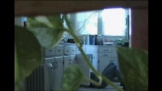 A married couple has fun while walking naked at home