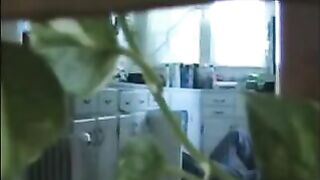 A married couple has fun while walking naked at home