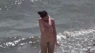 A couple of nudists enjoy each other in a steamy beach scene