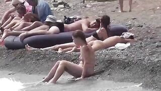 A couple of nudists enjoy each other in a steamy beach scene