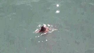 A couple enjoying themselves completely naked on the sea and beach