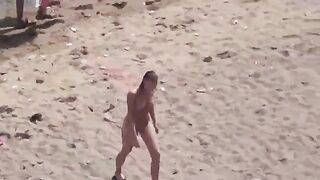 A couple enjoying themselves completely naked on the sea and beach