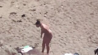 A couple enjoying themselves completely naked on the sea and beach