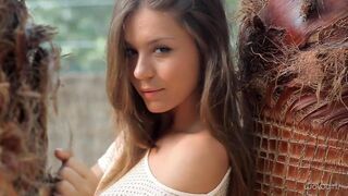 A nice woman is doing a striptease, showcasing her body in a sensual display