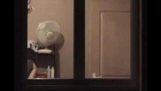 Guy admires his reflection in the mirror completely naked