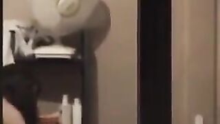 Guy admires his reflection in the mirror completely naked