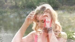 A blondie caresses herself on the shores of the lake