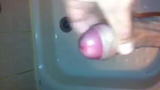 The kid masturbates his dick under a shower stream
