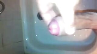 The kid masturbates his dick under a shower stream