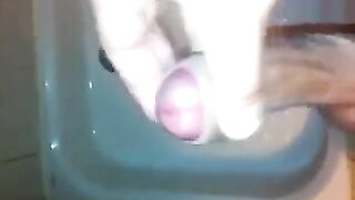 The kid masturbates his dick under a shower stream