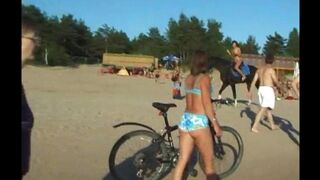 A man and a girl have sex directly on the beach