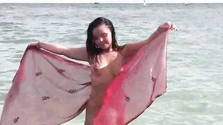A hot girl has a bath and plays with her boobs in the sea