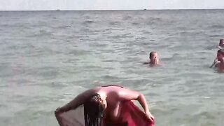 A hot girl has a bath and plays with her boobs in the sea