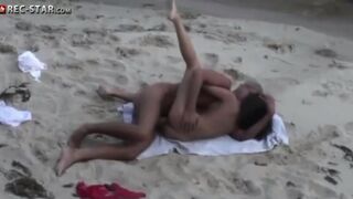 A couple has sex on the beach with a hidden camera capturing it all
