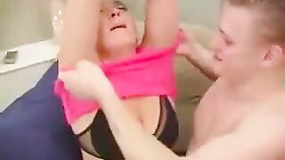A hot woman has sex with her grandson in a chair