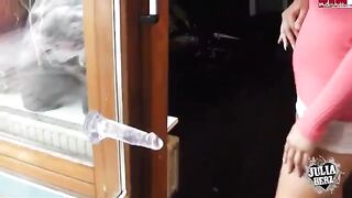 A girl with big boobs plays with a dump truck made of rubber