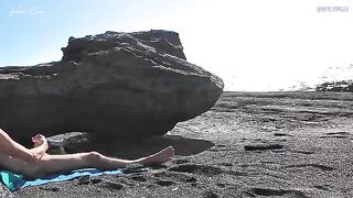 A girl has removed her swimming suit on the beach and masturbated