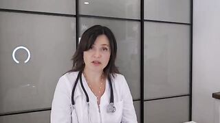 A happy girl has a huge ball under her blouse. The doctor checked the patient