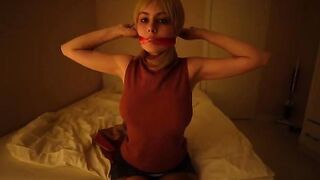 A girl dressed up as a character from Resident Evil masturbates with a toy